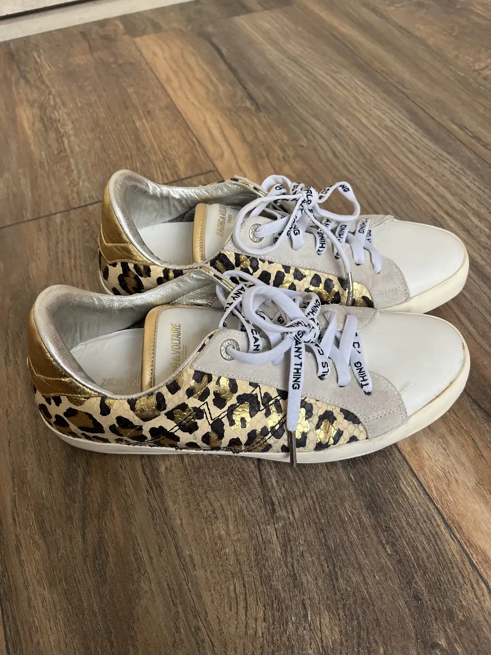 Zapatillas Zadig & Voltaire con estampado de leopardo, detalles dorados y cordones con inscripciones. Ideales para un look casual y con estilo.
