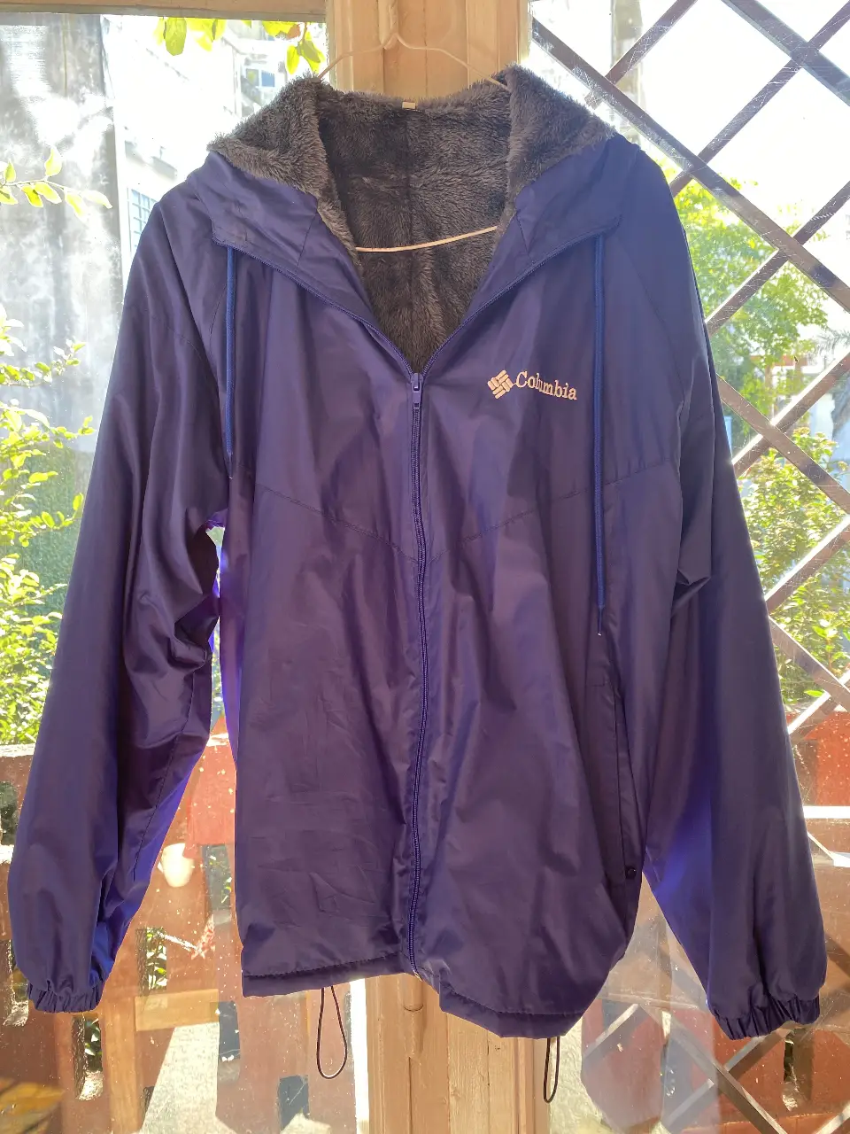 Campera Columbia azul con capucha y forro de piel sintética. Ideal para el otoño, con cierre y logo de la marca.
