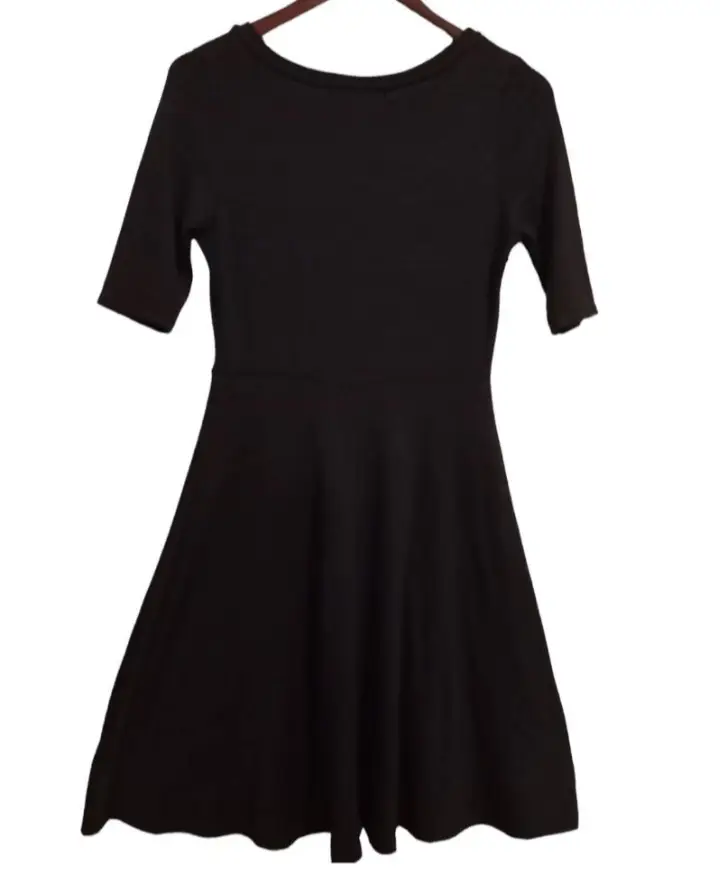 Vestido negro corto, ideal para una salida o evento. Corte entallado y falda con vuelo.