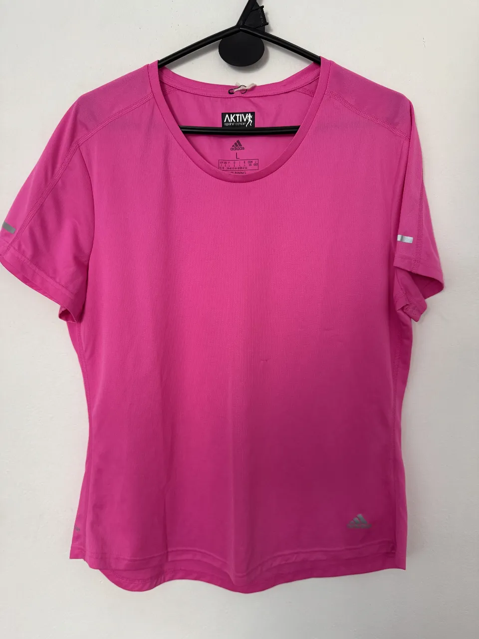 Remera deportiva Adidas Aktiv para mujer, de color rosa, manga corta, con tecnología Aeroready. Ideal para running y actividades físicas.
