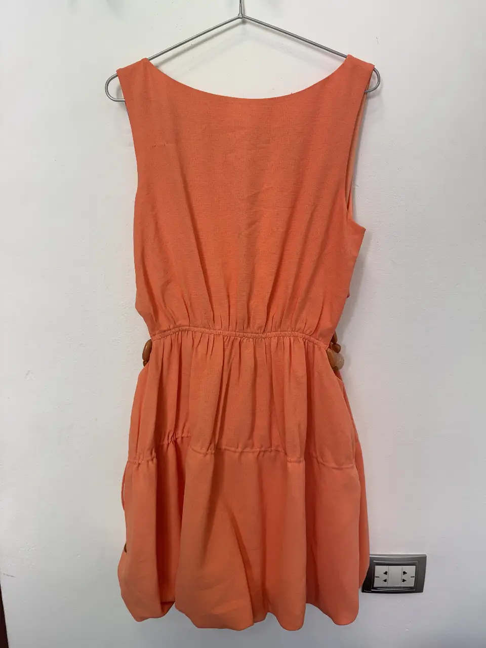 Vestido midi naranja de Jonathan Simkhai, con detalles de corte en los costados y adornos de cuentas plásticas.Ideal para un look fresco y moderno.