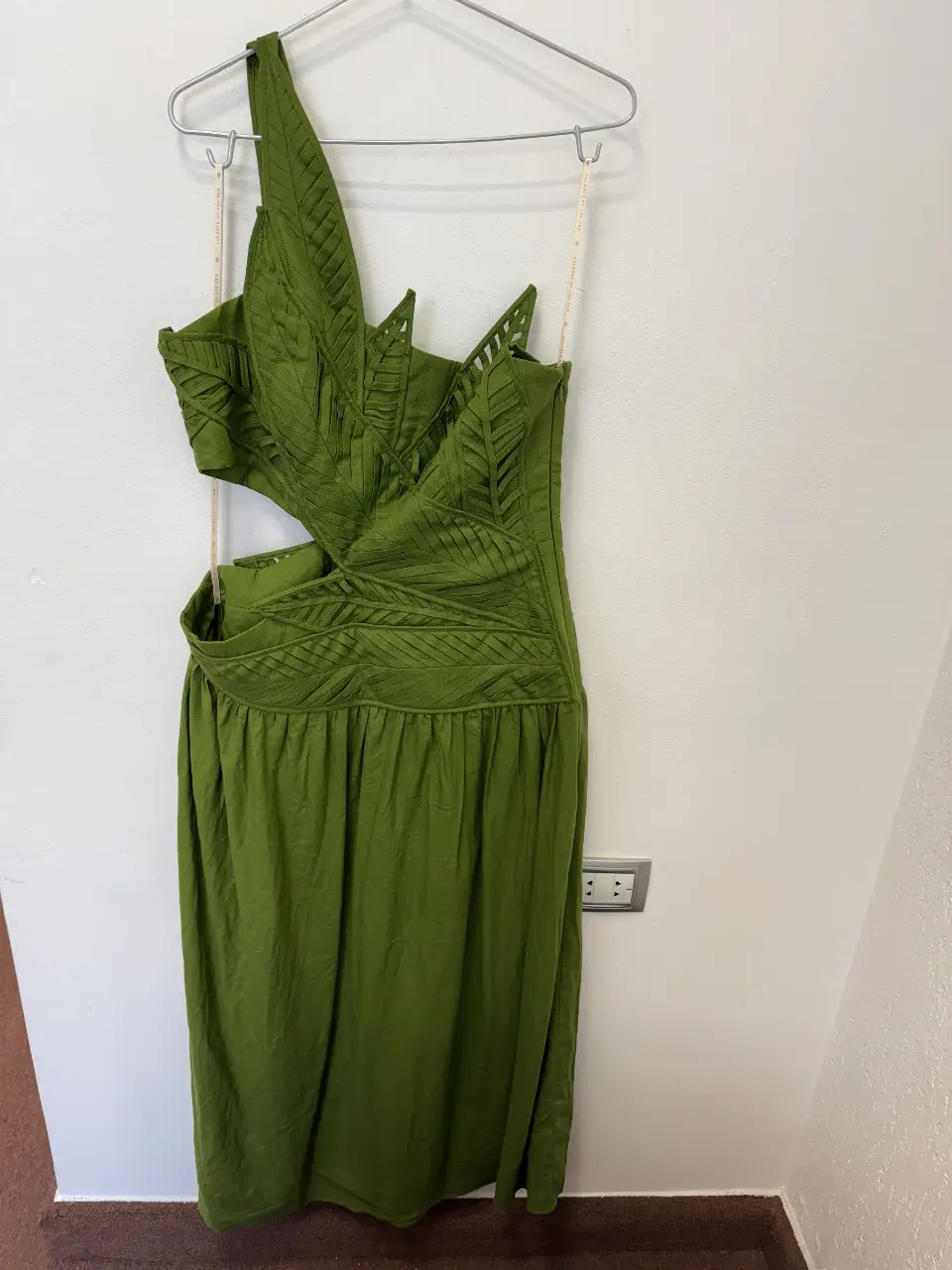 Vestido midi verde con diseño único y detalles calados. Corte asimétrico con un hombro descubierto y aberturas laterales. Ideal para eventos especiales o salidas.