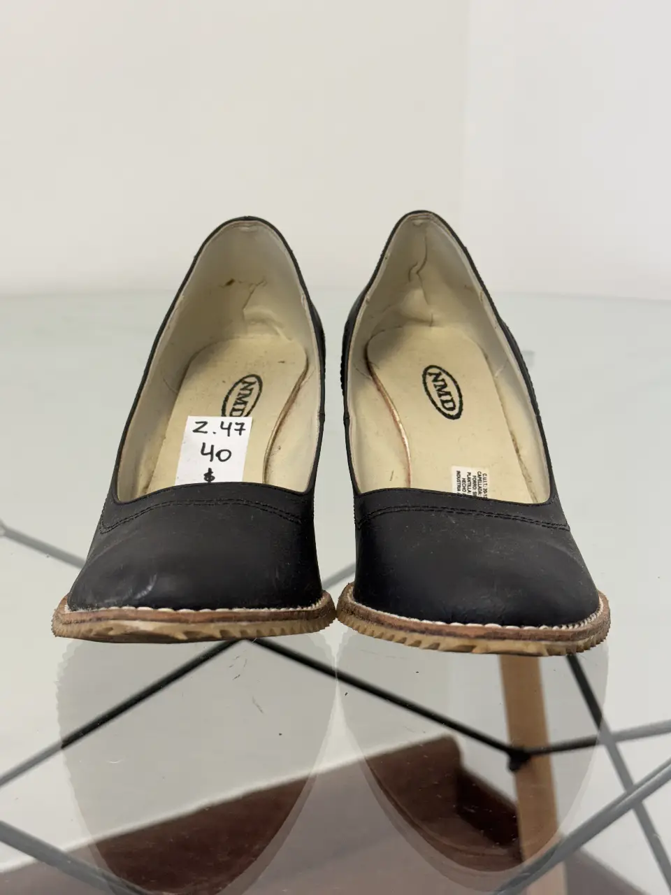 Zapatos de taco alto negros de cuero, con etiqueta de precio visible. Talle 40.