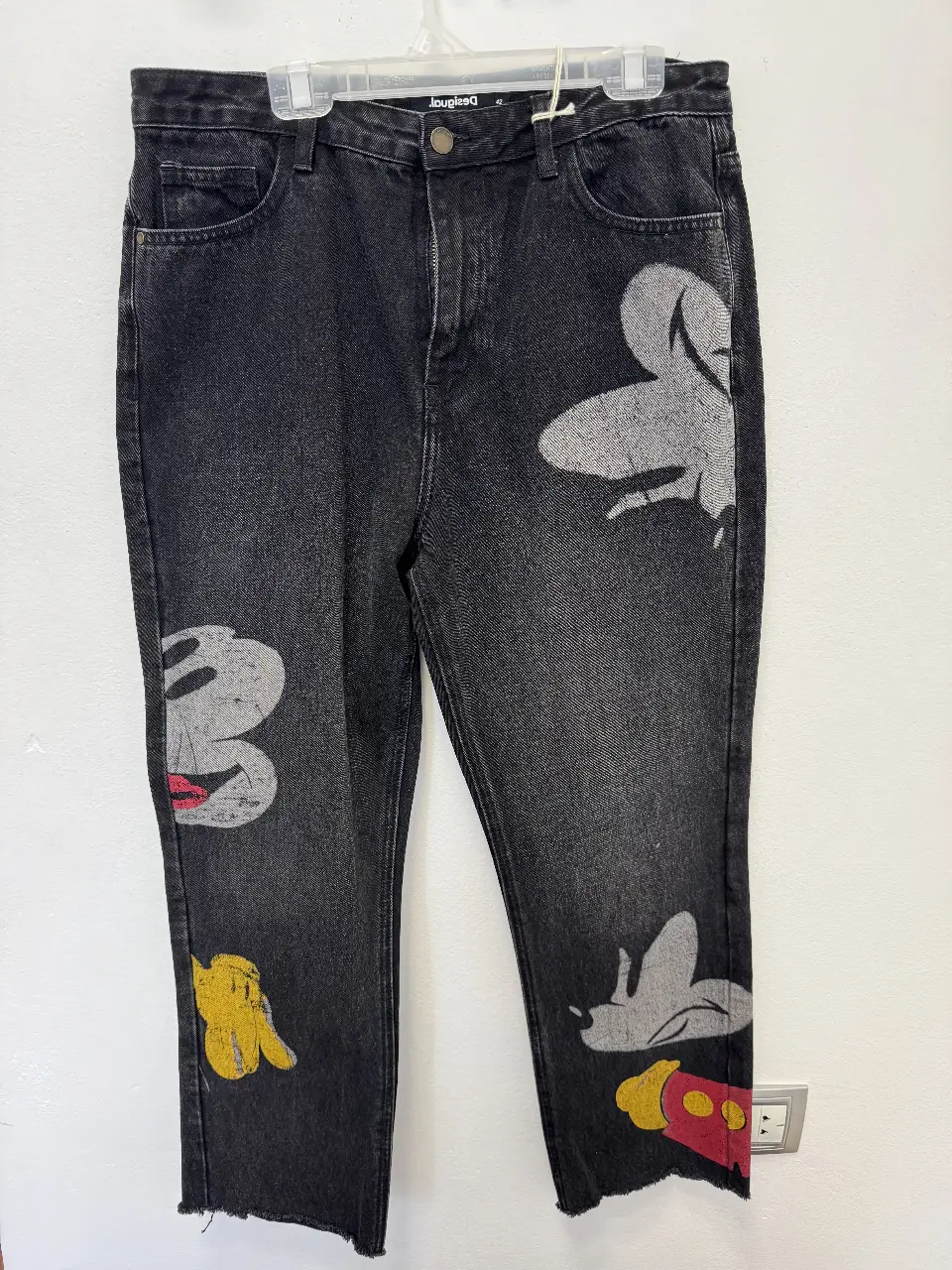 Jeans negro con diseño de Mickey Mouse. Talle 42. Corte recto, ideal para un look casual y canchero. Estampado de Mickey en la parte delantera y trasera.