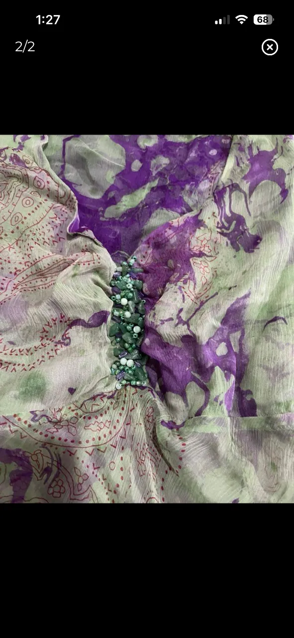 Blusa estampada con detalles de pedrería en el escote. Diseño único y vibrante, ideal para darle un toque especial a tu look.