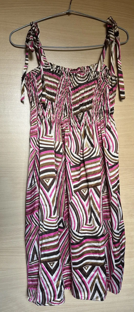 Vestido corto estampado con tiras finas y detalle fruncido en el busto. Ideal para un look fresco y canchero.