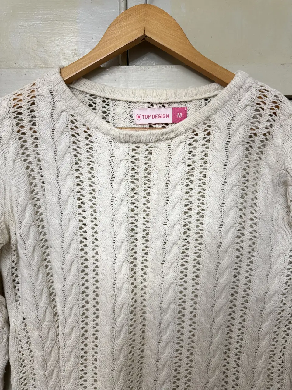 Sweater de mujer tejido en color crudo con diseño calado y manga larga. Ideal para un look casual y cómodo.