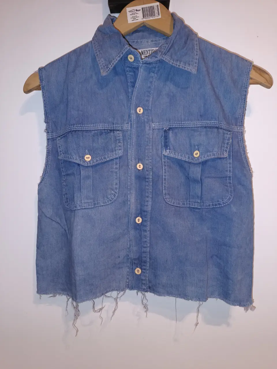 camisa/ chaleco de jean azul, con botones y bolsillos. Corte recto y detalles deshilachados en el borde inferior. Ideal para un look casual y canchero. Talle 12 (es un S de adulto) entre hombros:39cm Entre sisas:47cm Largo:47cm