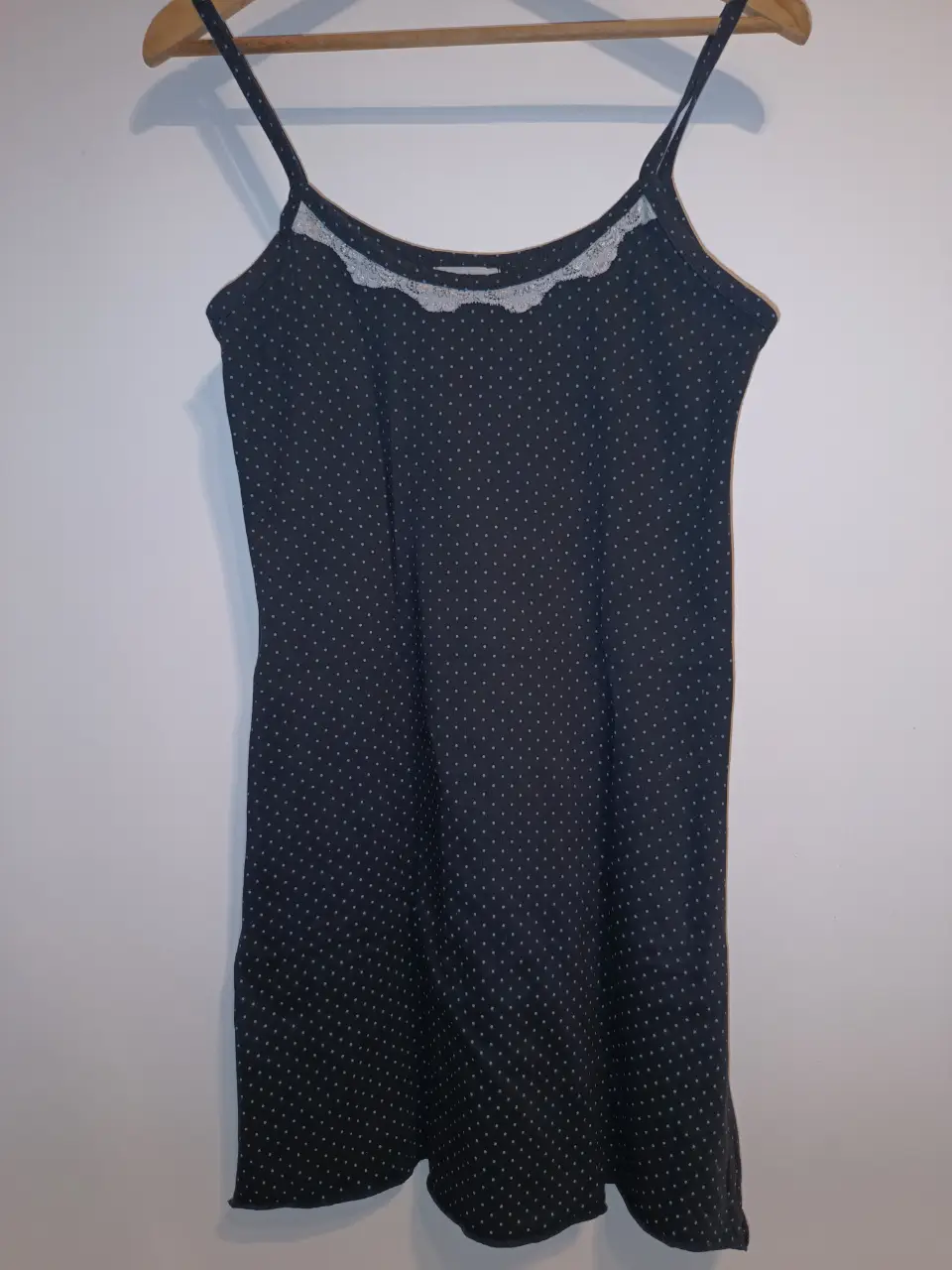 camisón/ camisolín de mujer, con estampado de lunares grises sobre fondo negro. Tiene tirantes finos y un detalle de encaje blanco en el escote. La marca es Lucía Navarro. entre sisas:46cm Cadera:94cm Largo:92cm
