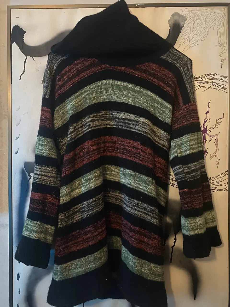 Sweater de cuello alto a rayas horizontales en tonos negro, verde y rojo. Ideal para hacer un look bien abrigado y hermo