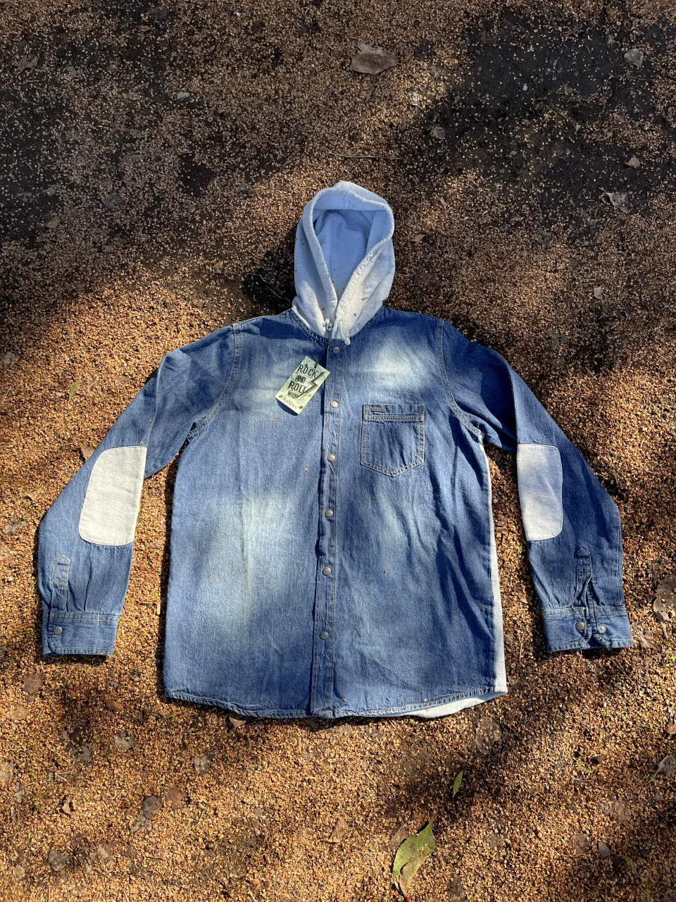 Campera de jean con capucha, ideal para un look urbano y canchero. Tiene parches en los codos y un estampado en la espalda que le da un toque único. Perfecta para el día a día. Talle 14