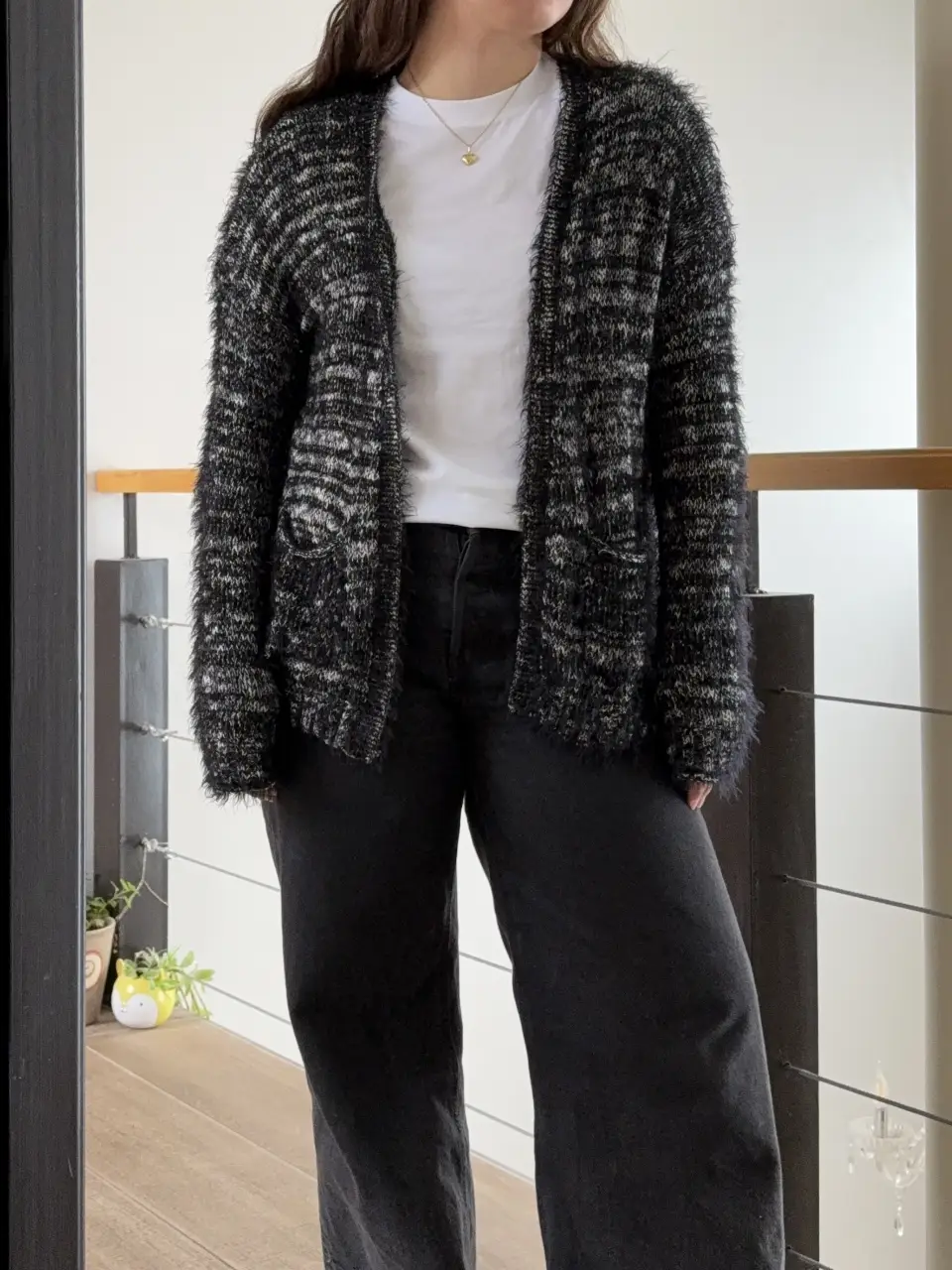 Cardigan de tejido peludo en tonos negro y blanco. Ideal para un look casual y abrigado.