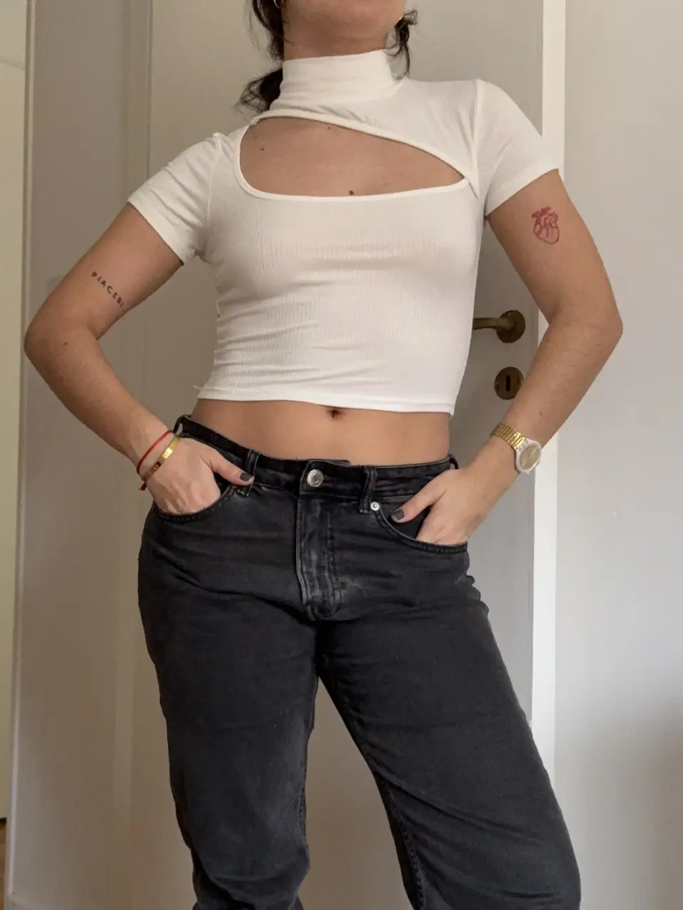 Top blanco con cuello alto y abertura en el pecho. Ideal para un look moderno y sofisticado. La remera se transparenta. 