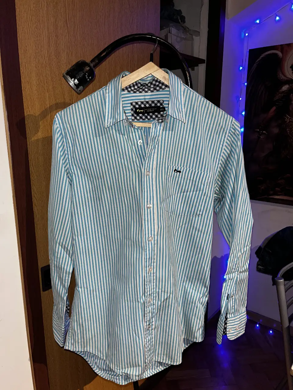 Camisa a rayas celeste y blanca de hombre marca ARTURO CALLE, importada Colombiana, manga larga, con bolsillo en el pecho y cuello con detalle a cuadros. Marca Arturo Calle Golf, talle P/S.