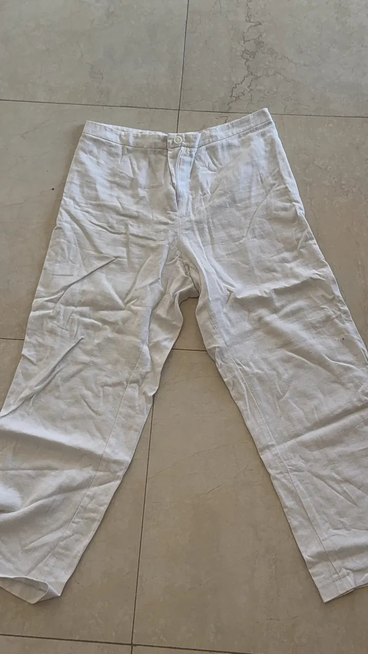 Pantalón blanco de lino con dos botones en la cintura y cierre.