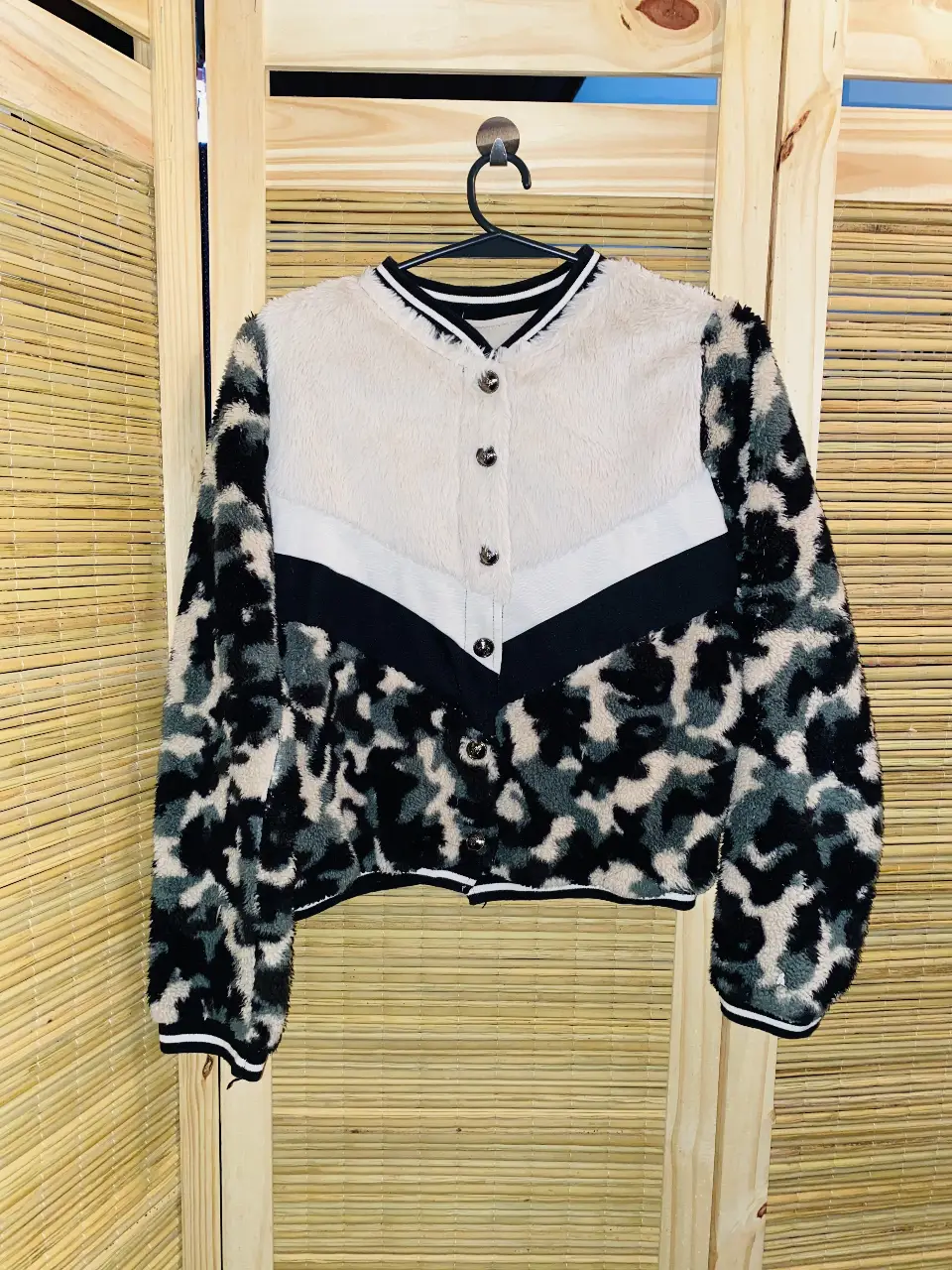 Campera bomber con diseño de estampado de leopardo en tonos grises y negros. Posee detalles en blanco y negro en el frente y cuello. de peluche. talle s.