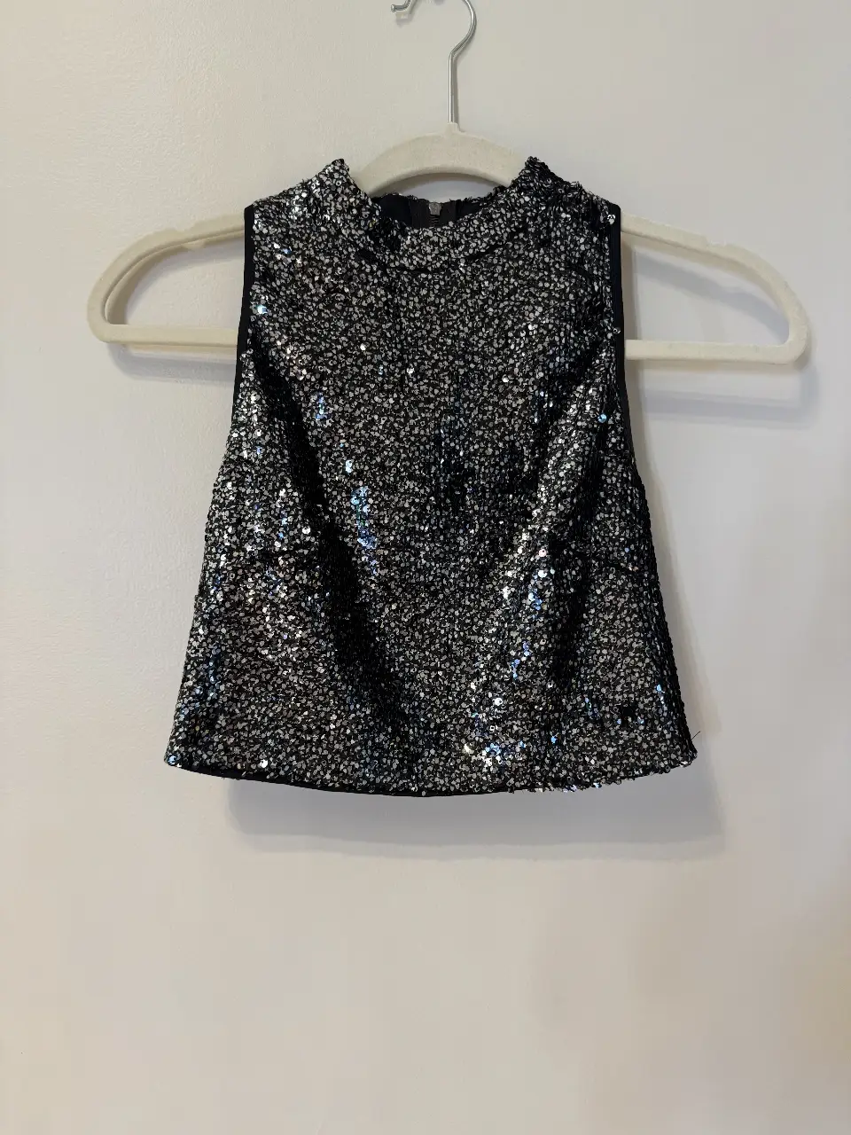 Top de fiesta Forever 21 con lentejuelas plateadas sobre fondo negro. Cuello alto y cierre en la espalda. Ideal para eventos y salidas.