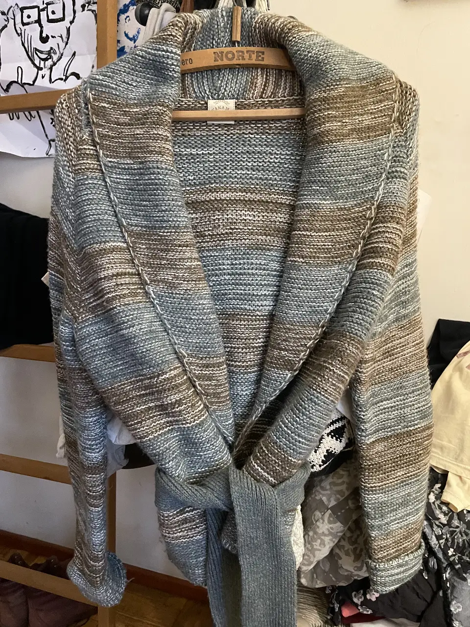 Cardigan tejido de lana con diseño a rayas en tonos grises y marrones. Ideal para un look casual y abrigado.