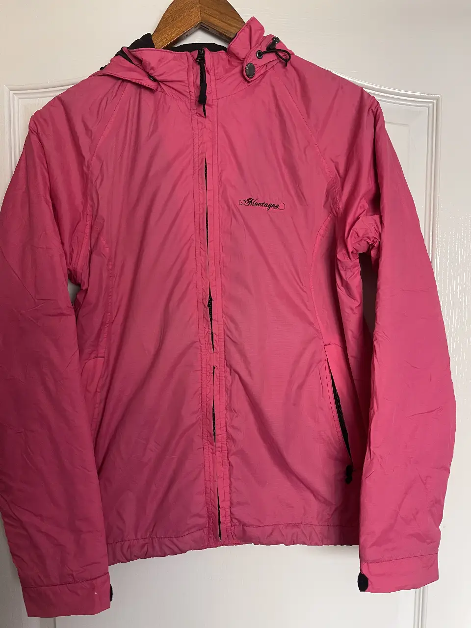Campera deportiva rosa de la marca Montagne, con capucha y cierre. Ideal para actividades al aire libre.