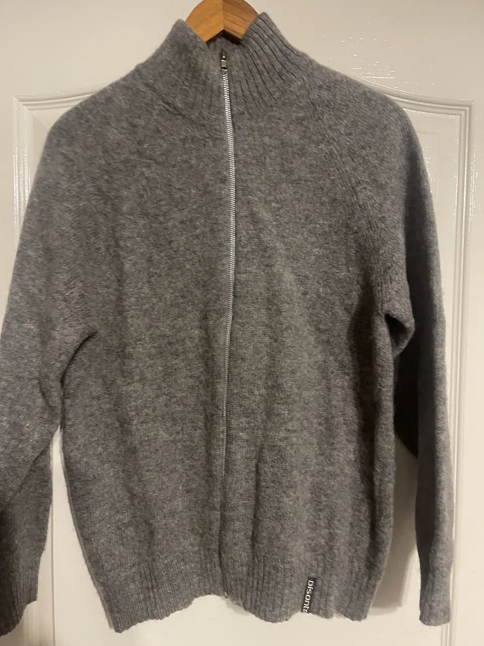 Sweater de hombre gris con cierre frontal y cuello alto. Ideal para el invierno, este sweater de lana es perfecto para un look casual y abrigado.