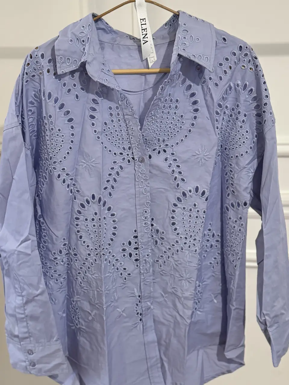 Camisa celeste con detalles calados, ideal para un look fresco y elegante. Perfecta para combinar con jeans o pantalones de vestir.