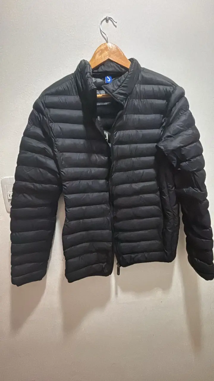Campera de pluma negra, ideal para el invierno. Talle S. Cierre frontal y cuello alto.
