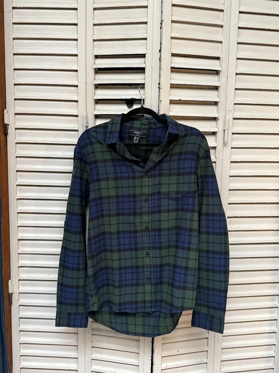 Camisa a cuadros de hombre, manga larga, en tonos verde y azul. Ideal para un look casual y cómodo.