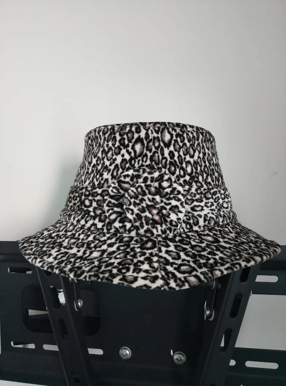 Sombrero de mujer con estampado de leopardo en blanco y negro. Cuenta con un detalle floral en la parte delantera.