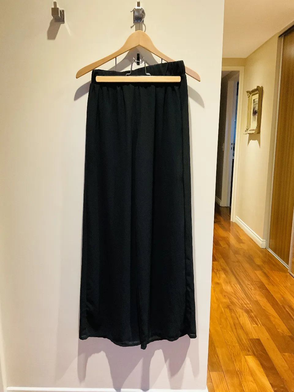 Pantalón negro palazzo de seda, ideal para un look elegante y sofisticado. Su corte ancho y fluido lo hace perfecto para cualquier ocasión, desde una salida casual hasta un evento formal. Combinalo con un top o blusa para un outfit completo.