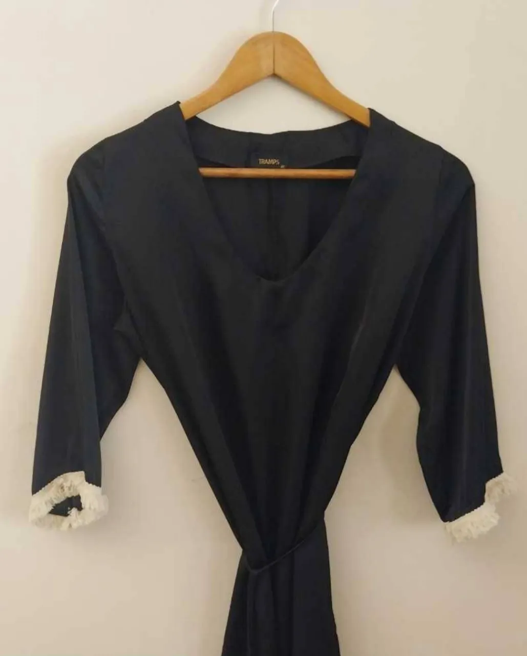 Vestido negro de seda con mangas 3/4 y detalles de encaje blanco en los puños. Incluye lazo para ajustar a la cintura. Talle M.
Medidas: Hombros: 37cm. Busto: 50cm. Largo: 86cm. 