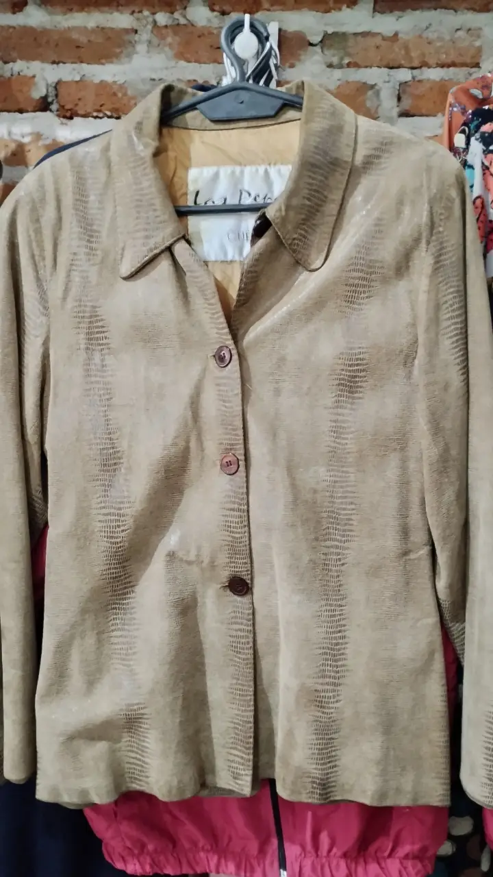 Chaqueta de cuero sintético color marrón claro con botones. Ideal para un look casual y elegante.