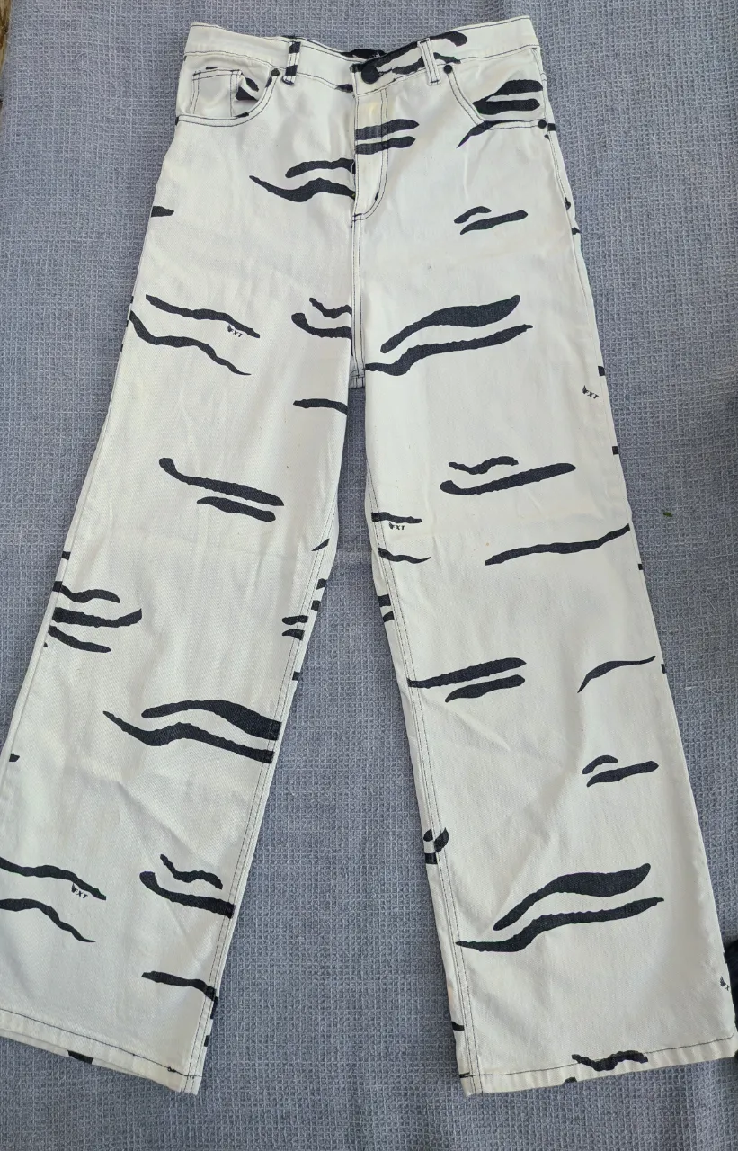 Jeans blancos con estampa de líneas negras irregulares. 