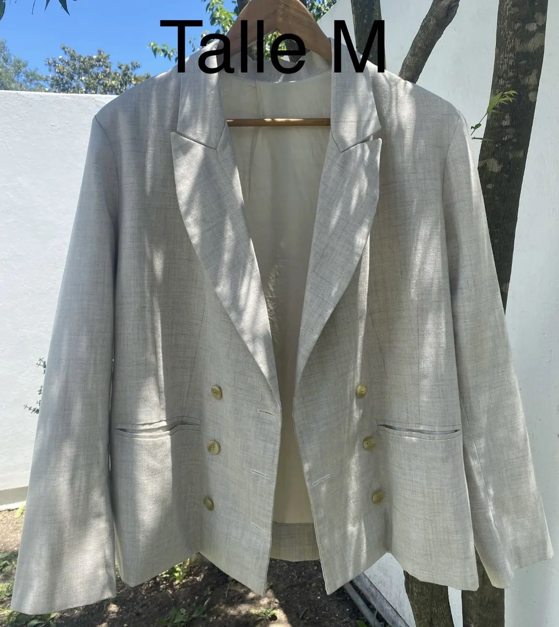 Blazer de lino color crudo, con doble abotonadura y bolsillos frontales. Ideal para un look elegante y sofisticado.