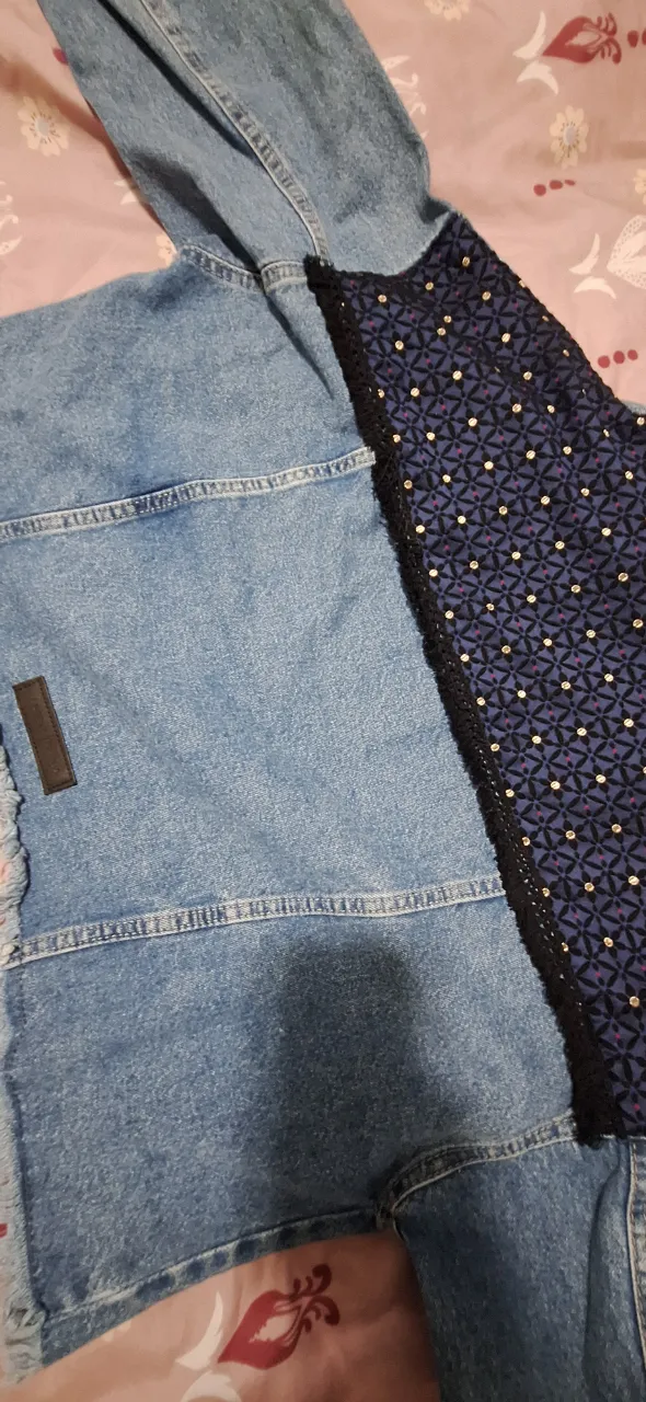 Campera de jean azul con detalles en tela estampada en la espalda. Corte clásico, ideal para un look casual y canchero.