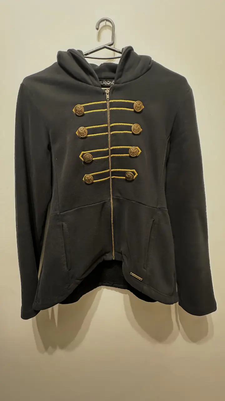 Campera negra con capucha y cierre frontal. Detalles dorados en botones y costuras. Ideal para un look casual con un toque elegante.
