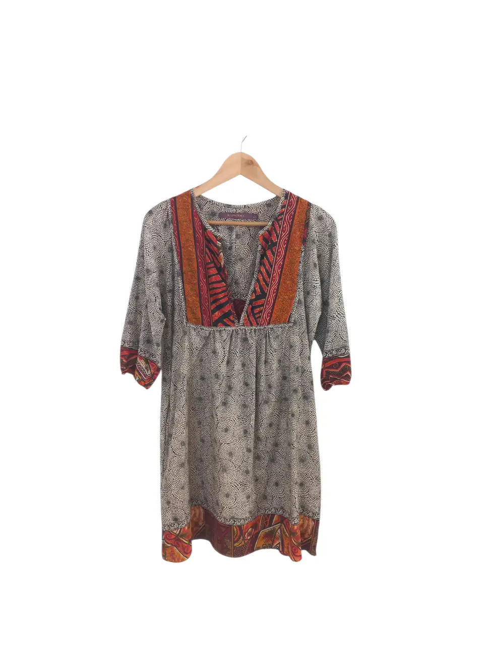 VESTIDO RAPSODIA TALLE S. LARGO 85, AXILA 48, CADERA 60, MANGAS (DESDE EL CUELLO) 50. CON BOLSILLOS. POLIESTER. Vestido midi con estampado floral en blanco y negro, con detalles en naranja y rojo. Cuello en V y mangas 3/4. Ideal para un look casual y bohemio.