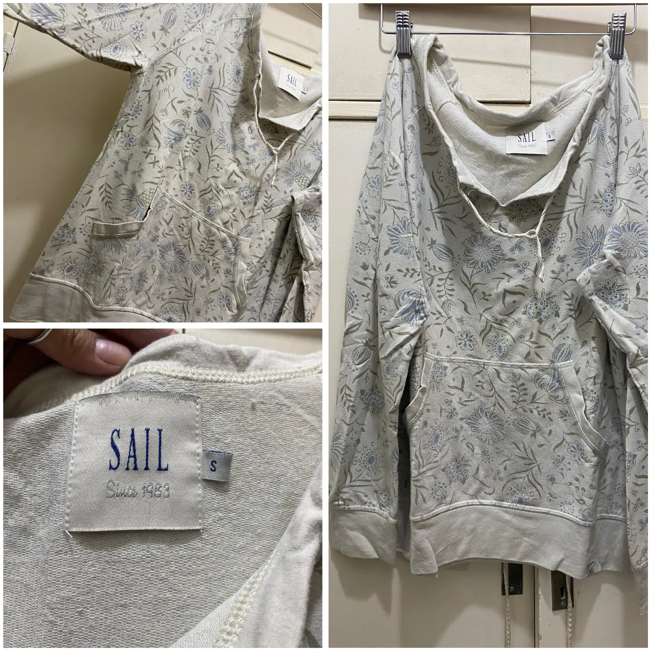 Buzo canguro de algodón con estampado floral en tonos azules y blancos. Tiene un bolsillo delantero y el logo de la marca en la etiqueta. Ideal para un look casual y cómodo.