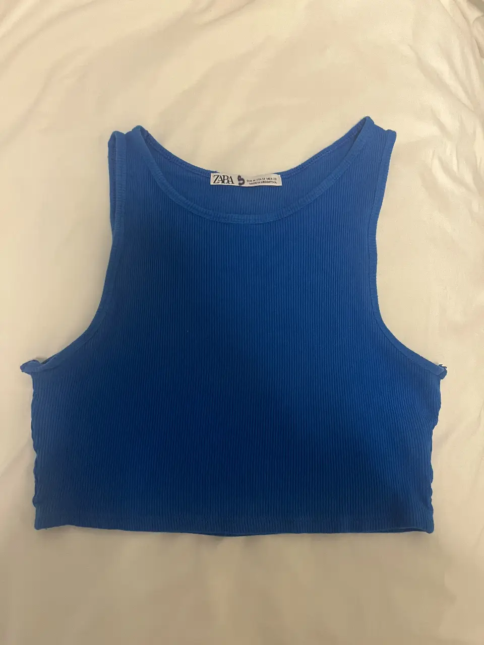 Top de mujer azul, de tela acanalada, ideal para un look casual y moderno. Perfecto para combinar con jeans o shorts.