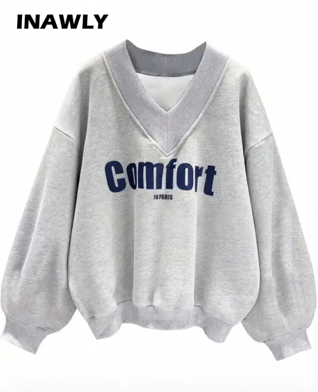 Buzo de mujer gris con cuello en V y mangas amplias. Diseño "Comfort in Paris" estampado en azul marino. Ideal para un look casual y cómodo.