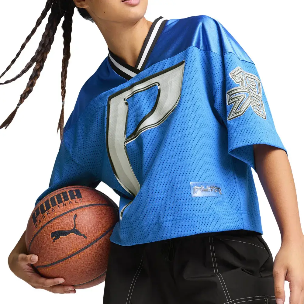 Remera deportiva de hombre Puma, de manga corta y cuello en V con detalles en blanco y negro. Diseño con el logo "P" en grande y el logo de la marca en la parte inferior. Ideal para un look deportivo y urbano.