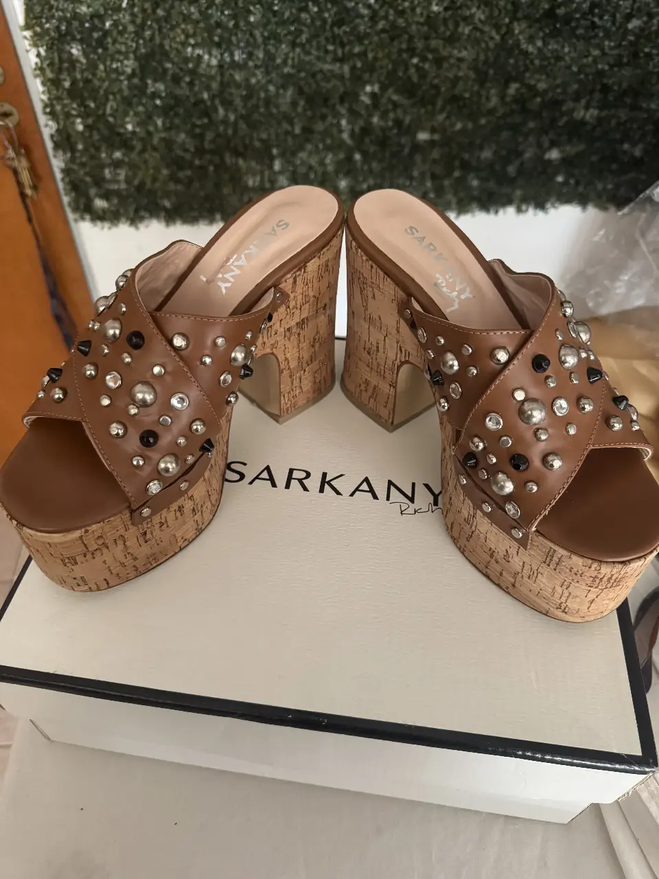 Sandalias de mujer con plataforma y taco ancho, estilo zueco. Diseño con apliques de tachas plateadas y negras, detalles de cuero y base de corcho. Ideales para un look moderno y canchero.