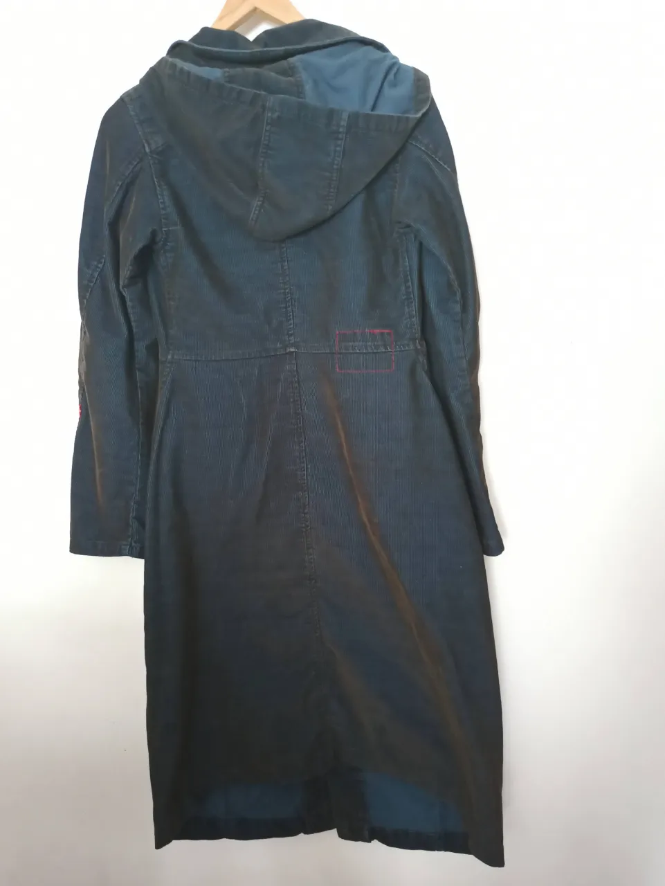 Abrigo largo de pana con capucha, ideal para días frescos. Diseño clásico con bolsillos internos y detalles únicos. Perfecto para un look casual y moderno.