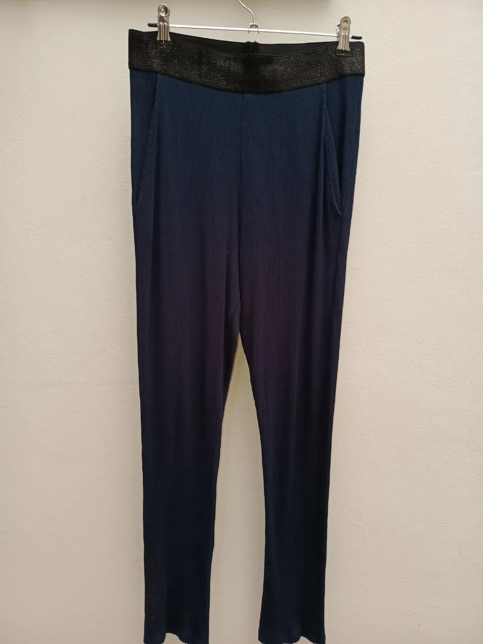 Pantalón azul marino de tela acanalada con cintura elastizada negra.