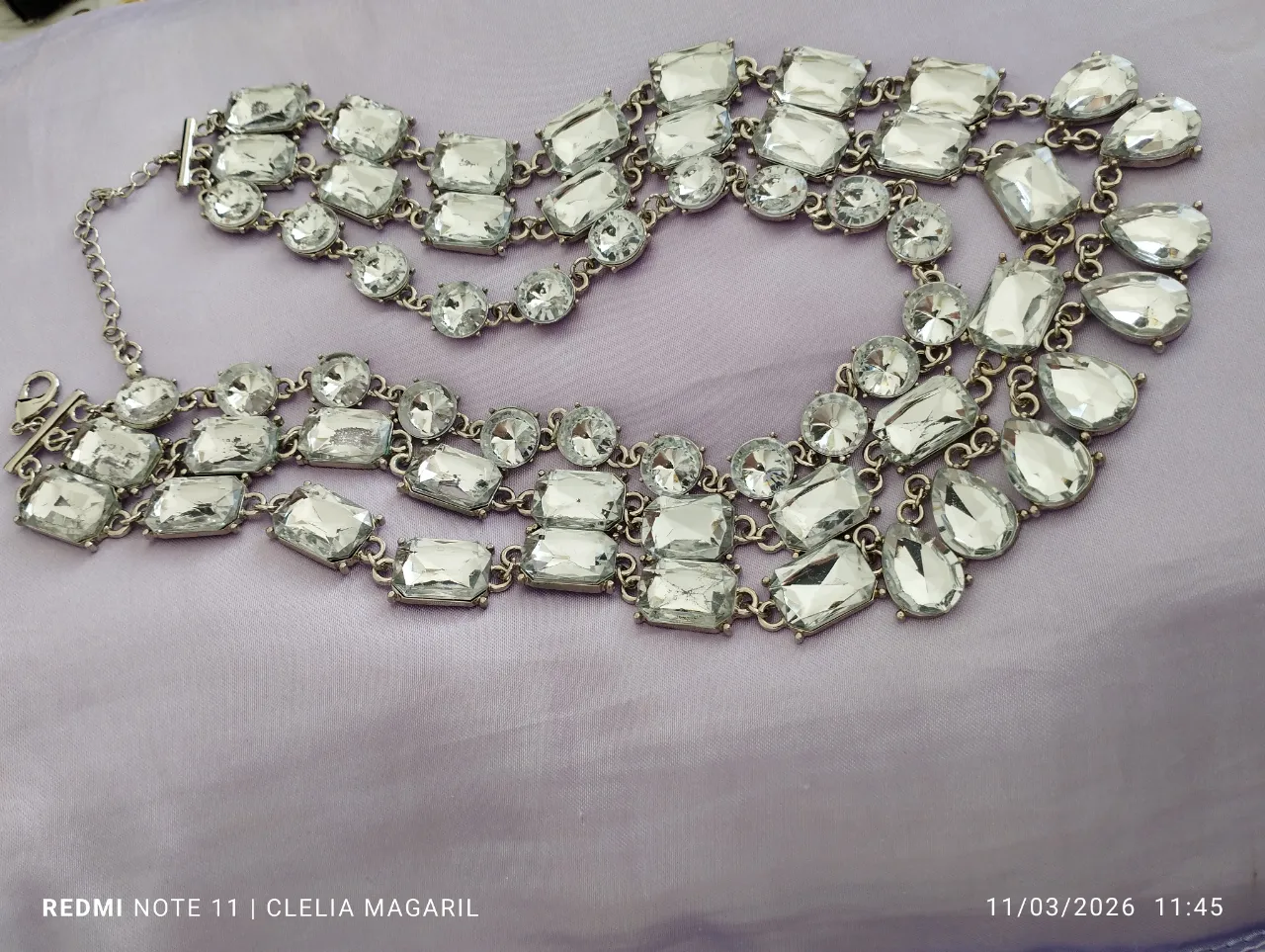 Collar de tres hileras con piedras transparentes facetadas y eslabones plateados, de forma diferente en cada hilera. Cierre tipo T. Muy llamativa. Ideal para una fiesta o lucir de noche...
