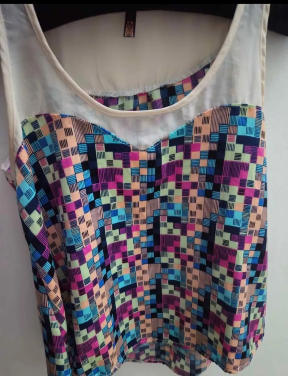 Top de mujer con estampado geométrico en tonos vibrantes. Diseño con escote en forma de corazón y espalda descubierta. Ideal para un look moderno y fresco.