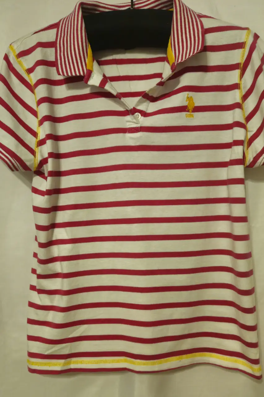 Remera polo a rayas rojas y blancas con detalles amarillos. Logo de la marca en el pecho. Ideal para un look casual y deportivo.