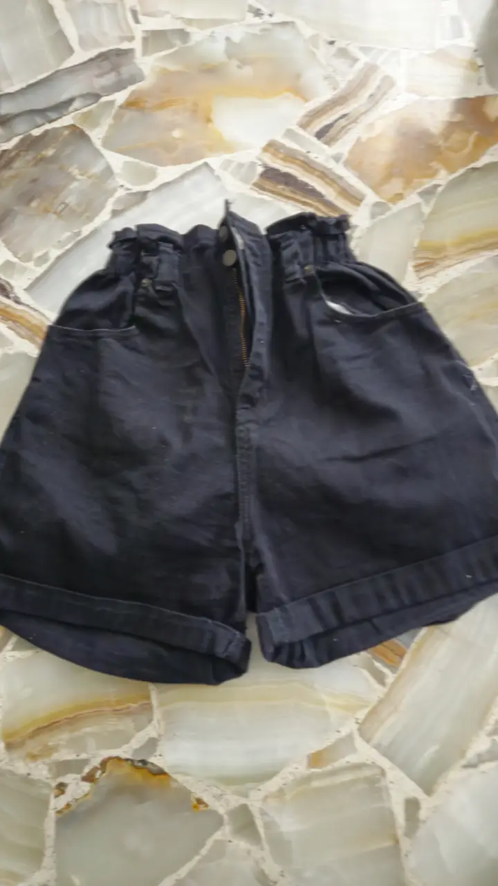 Short de jean negro con cintura elastizada y bolsillos. Ideal para un look casual y cómodo.