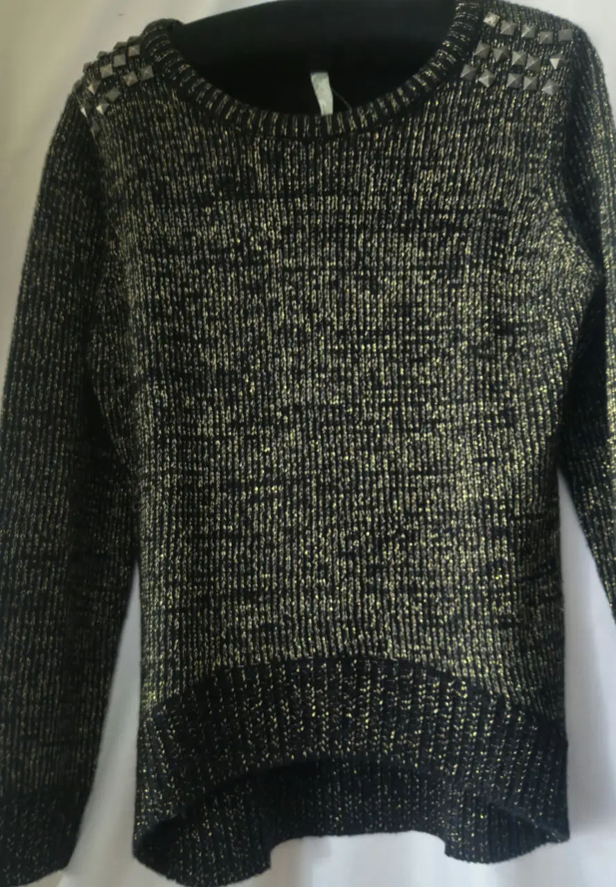 Sweater largo de mujer, negro con detalles dorados y tachas en los hombros. Ideal para un look elegante y abrigado.