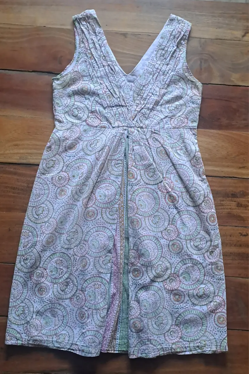 Vestido midi de mujer, con estampado floral en tonos pastel. Diseño con escote en V y detalle de fruncido en el pecho. Ideal para un look casual y fresco.