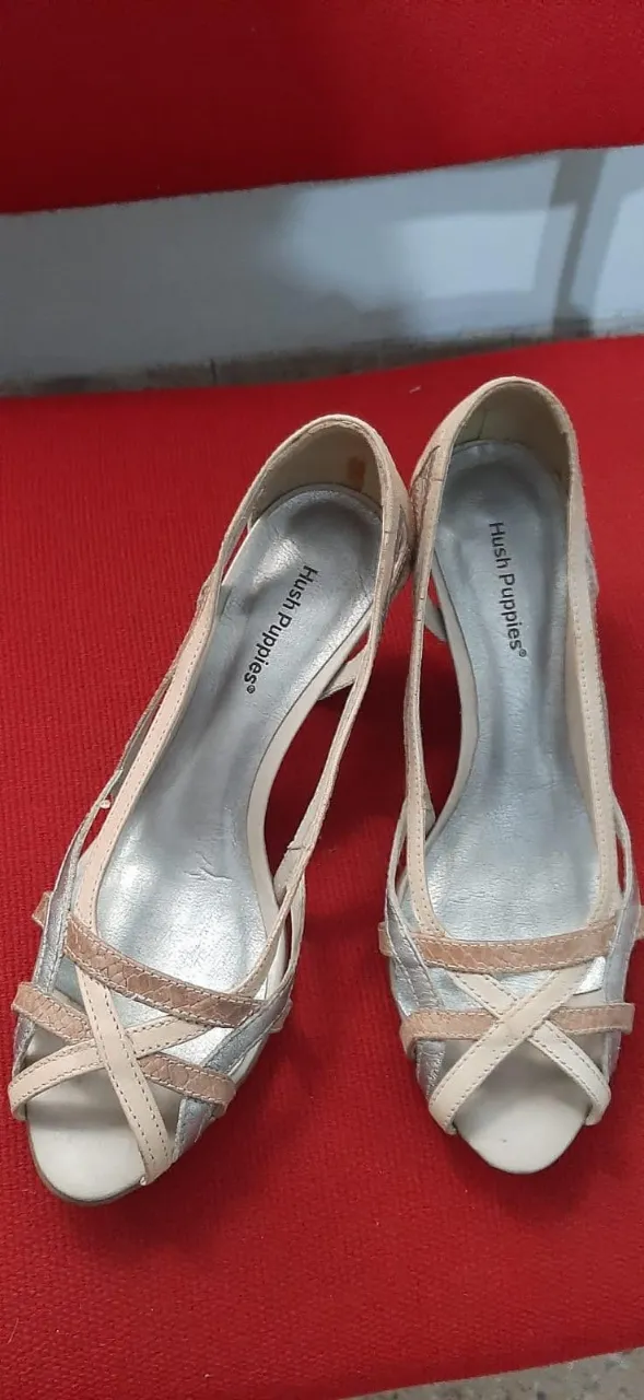 Sandalias Hush Puppies para mujer, con diseño elegante y detalles en plateado y blanco. Ideales para complementar cualquier look de verano.